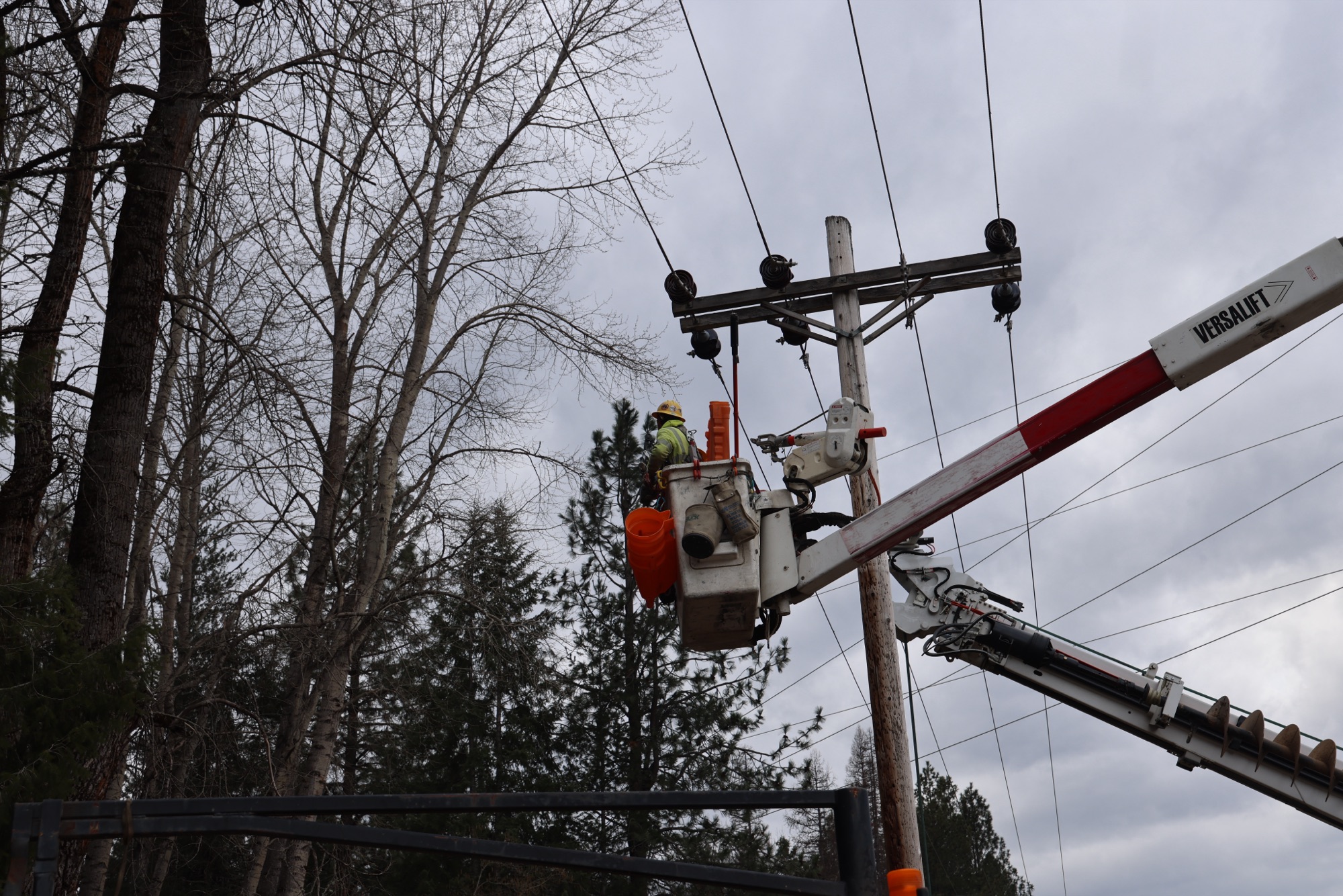 Lineworker in a bucket truck working on an energized distribution structure